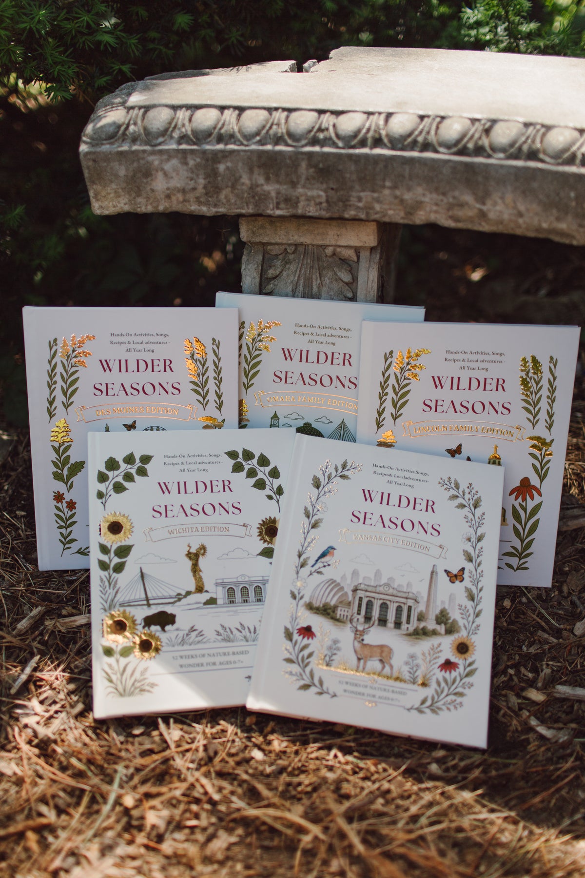 Five Wilder Seasons city edition guidebooks displayed together outdoors
