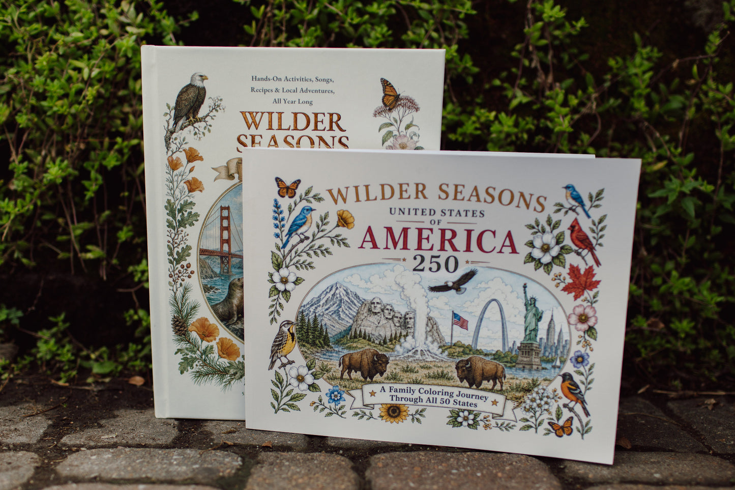 Wilder Seasons USA Family Edition and USA Coloring Book displayed together outdoors